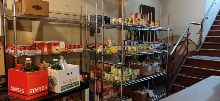 Food on rolling racks in a hallway.